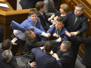 Communist lawmakers scuffle with right-wing Svoboda ( Freedom) Party lawmakers during a parliament session of Verkhovna Rada, the Ukrainian parliament, in Kiev, Ukraine Tuesday, April 8, 2014. (AP Photo/Vladimir Strumkovsky)